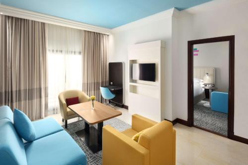 a living room with a couch and a table in a room at Park Inn by Radisson Makkah Al Naseem in Makkah