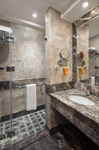 a bathroom with a sink and a shower at Park Inn by Radisson Makkah Al Naseem in Makkah