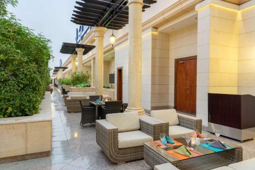 a patio at a hotel with chairs and tables at Park Inn by Radisson Makkah Al Naseem in Makkah