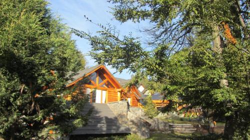 a log home with stairs leading up to it at La Estancia Cabañas in Villa La Angostura