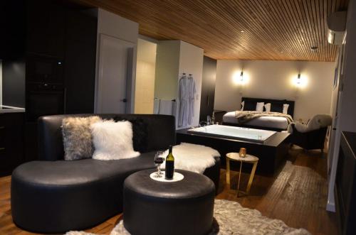 a room with a bed and a couch and a chair at Kudos Villas - Hepburn Springs in Hepburn Springs