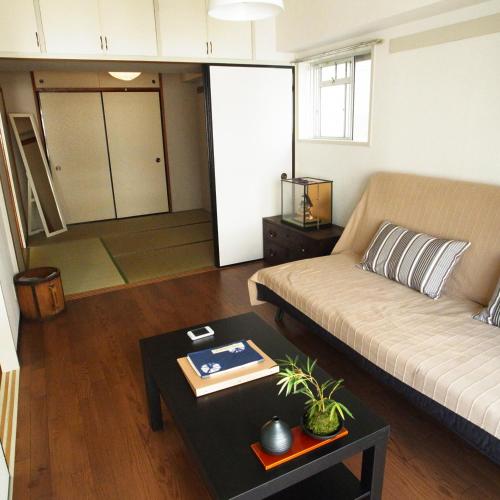 a living room with a couch and a table at Asayake in Tokyo
