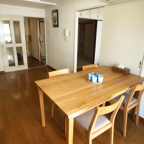 a wooden table and chairs in a living room at Asayake in Tokyo