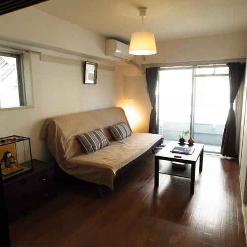 a living room with a couch and a table at Asayake in Tokyo