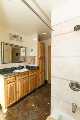 a bathroom with a sink and a mirror at Eagle Peak Guesthouse in Eagle River