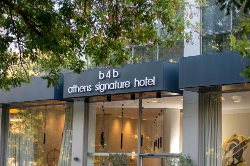 a building with a sign that readsdb offers signature hotel at B4B Athens Signature Hotel in Athens