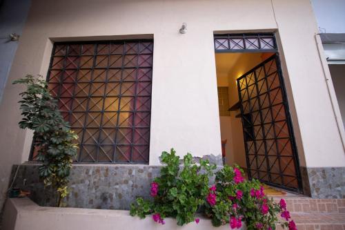 a building with flowers in front of a door at Apartment in the Plaza de Armas Cusco in Cusco