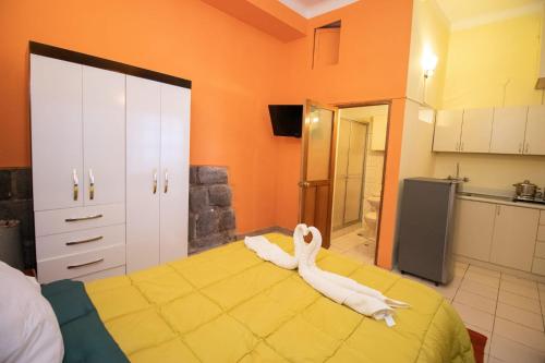 a room with a bed with a white animal on it at Apartment in the Plaza de Armas Cusco in Cusco