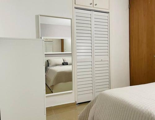 a bedroom with a closet with a mirror and a bed at Hollywood Apartments in Yabucoa