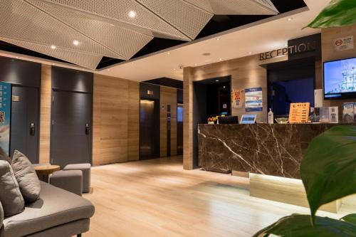 a lobby of a hotel with a reception desk at City Inn Macau in Macau