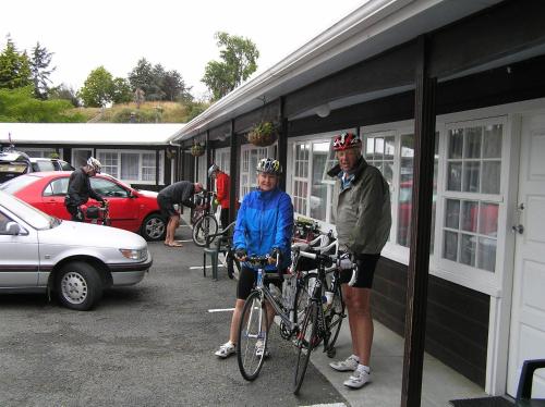 a man and a woman standing next to their bikes at Coachman Motel in Taihape