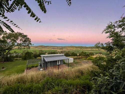 a house on the side of a hill with a view at Kiambram Country Cottages in Gowrie Little Plain