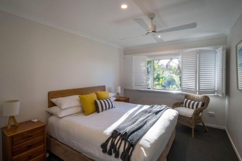 a bedroom with a large bed and a window at Cod Rock Point in Bicheno