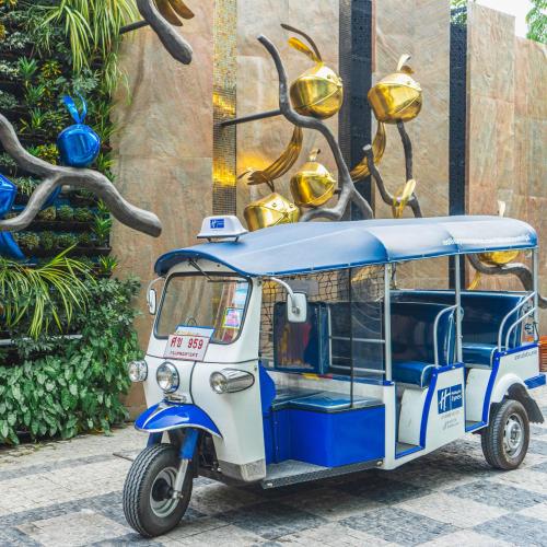 a small blue and white vehicle parked on a street at Holiday Inn Express Bangkok Soi Soonvijai by IHG in Bangkok