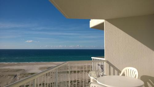 a balcony with a table and chairs and the ocean at Meridian Tower Kirra Beach in Gold Coast