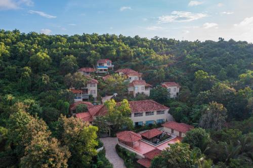 an aerial view of a home in a forest at Amritara Aura Resort & Spa in Mandrem
