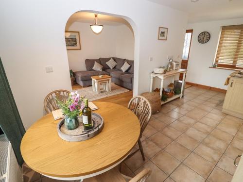 a living room with a table and a couch at The Honey Pot in Chepstow