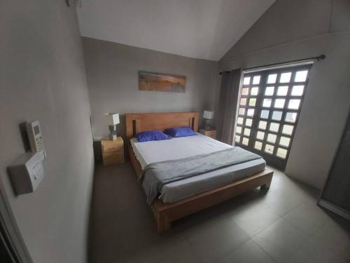 a bedroom with a bed and a large window at Vanz Villa in Mont Choisy