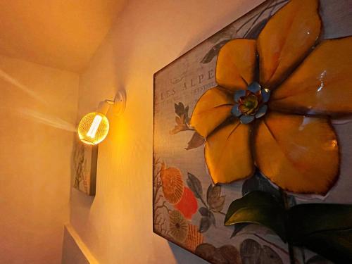 a painting of a flower on a wall at The Road Hotel in Seoul