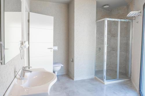 a bathroom with a shower and a sink and a toilet at ZEF RESIDENCE in Bodrum City