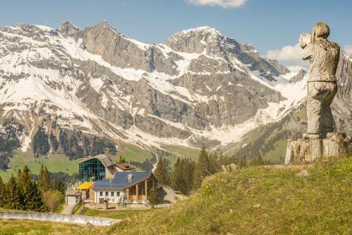 a statue of a bear standing on a mountain at Berglodge Ristis in Engelberg