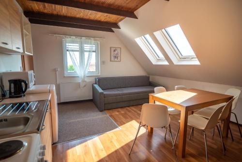 a kitchen and living room with a table and a couch at Mikulov - Inn - hotel s vinným sklepem Venuše in Mikulov