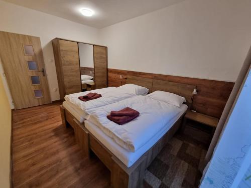 a bedroom with a bed with two towels on it at Villa-Gallant in Poprad