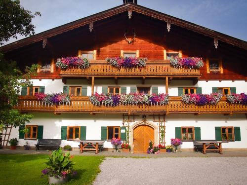a building with flower boxes on the front of it at Biobauernhof Stegerbauer in Maria Alm am Steinernen Meer
