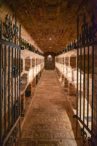 a long hallway of a wine cellar with wine bottles at Mikulov - Inn - hotel s vinným sklepem Venuše in Mikulov