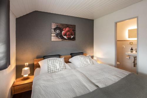 a bedroom with a large white bed and a sink at Finkenhof in Schluchsee