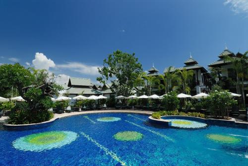 a swimming pool at a resort with umbrellas at The Zign Hotel Premium Villa in North Pattaya