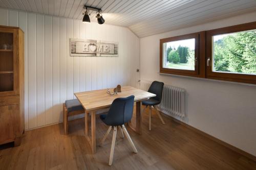 a room with a wooden table and two chairs at Finkenhof in Schluchsee