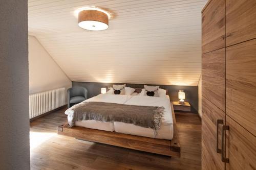 a bedroom with a large bed in a attic at Finkenhof in Schluchsee