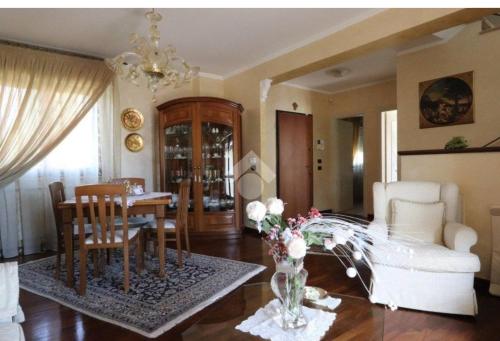 a living room with a table and a dining room at A L'Aquila per un sogno in LʼAquila