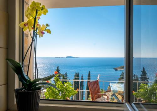 a window with a view of the ocean at Apartments Katica in Mlini