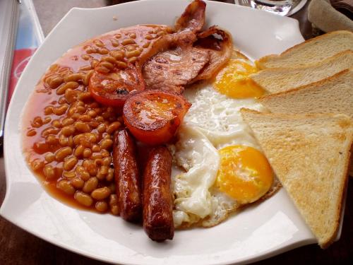 a plate of breakfast food with eggs beans and toast at Hays Suites Hotel in Nairobi