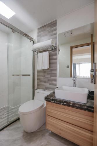 a bathroom with a toilet and a sink and a shower at Hotel Casiana & Events Center Tagaytay in Tagaytay