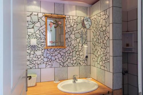 a bathroom with a sink and a mirror at Pagali Hotel in Órmos Aiyialís