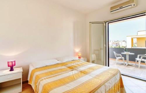 a bedroom with a large bed and a balcony at Residence Ionian Gallipoli in Gallipoli
