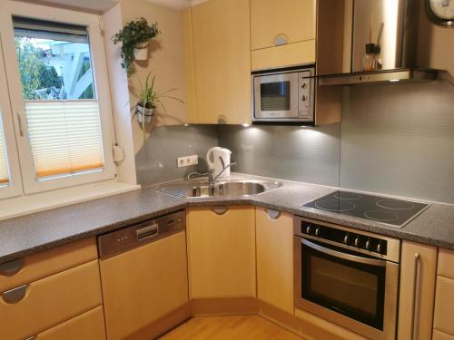a kitchen with a sink and a stove top oven at Ferienwohnung Christina in Ried im Zillertal