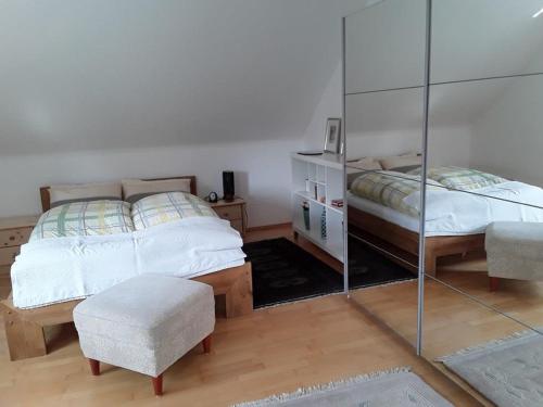 a bedroom with two beds and a mirror at Ferienwohnung Natur pur in Bad Pyrmont