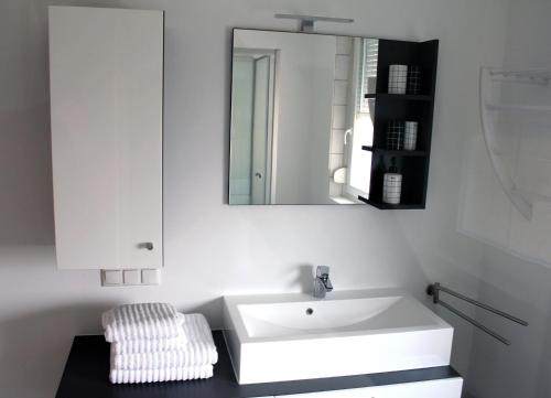 a bathroom with a white sink and a mirror at Appartement Michelle in Neusiedl am See