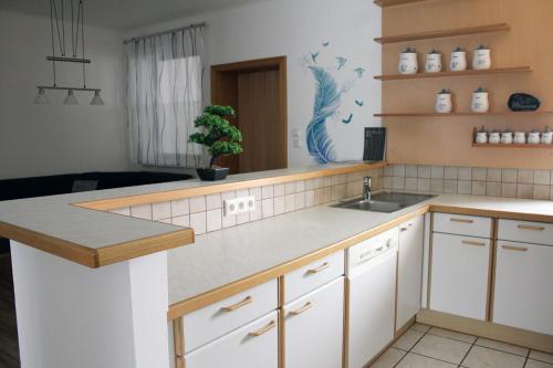 a kitchen with a sink and a counter top at Appartement Michelle in Neusiedl am See