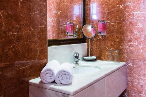 łazienka z umywalką i ręcznikami w obiekcie Kyveli Suites w Nauplionie