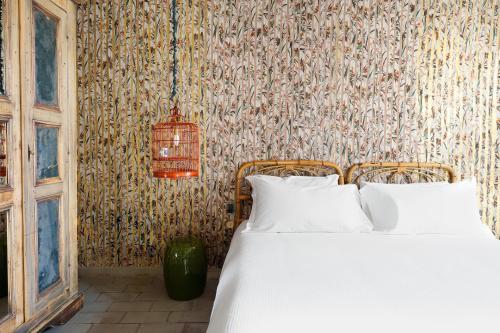 a bedroom with a bed and a wall at Numa Florence Rodo in Florence