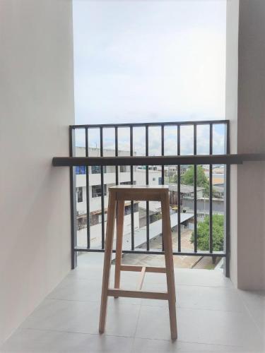a wooden chair sitting in front of a window at LA PINO HOTEL in Songkhla