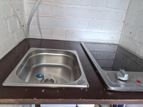 a stainless steel sink in a counter top at Privater Eingang mit Fußbodenheizung und Swimmingpoolblick - Ruhe und Erholung garantiert in Troisdorf