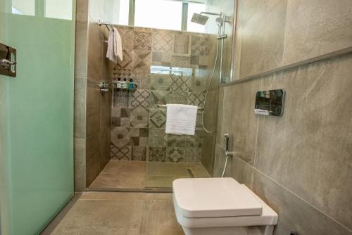 a bathroom with a toilet and a shower at Skynest Residences by CityBlue, Nairobi Westlands in Nairobi