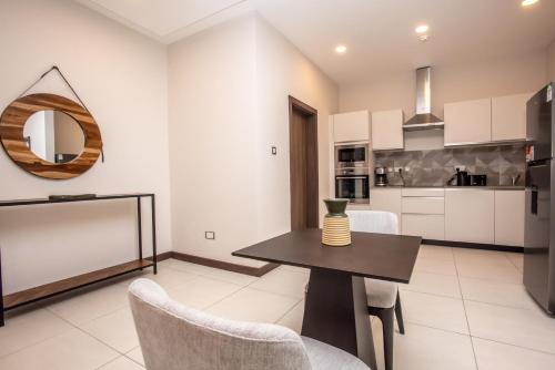 a kitchen and dining room with a table and chairs at Skynest Residences by CityBlue, Nairobi Westlands in Nairobi