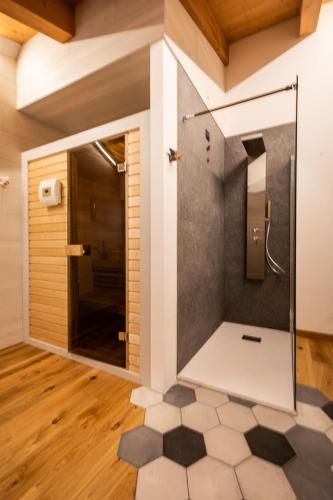 a bathroom with a shower with a tiled floor at CASA VACANZE RANUNCOLO 6 in Sùtrio